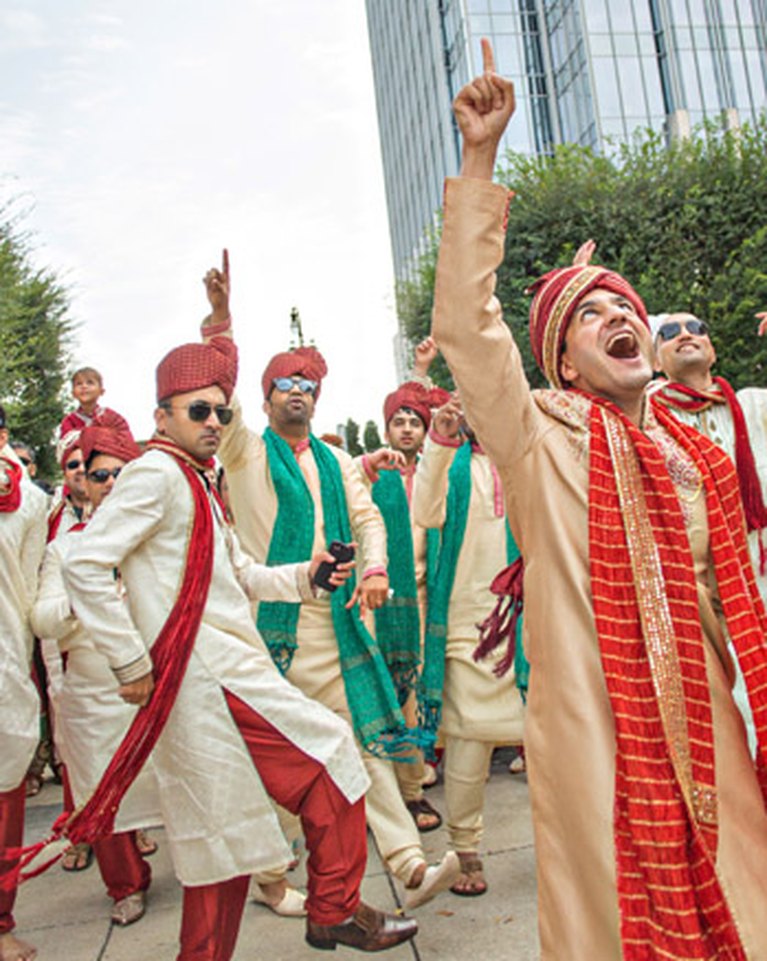 The baraat arriving, with the groom leading the procession